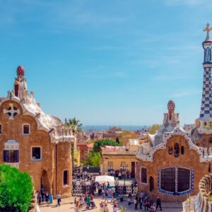 set to the backdrop of clear blue sky you can see two fantastic gaudi buildings, with the unique neo gothic style of ceramics.